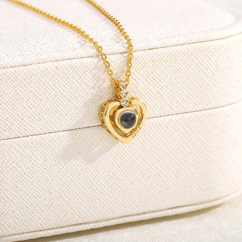 A close up photo of gold color I love you necklace focusing purely on the pendant of the necklace.  
