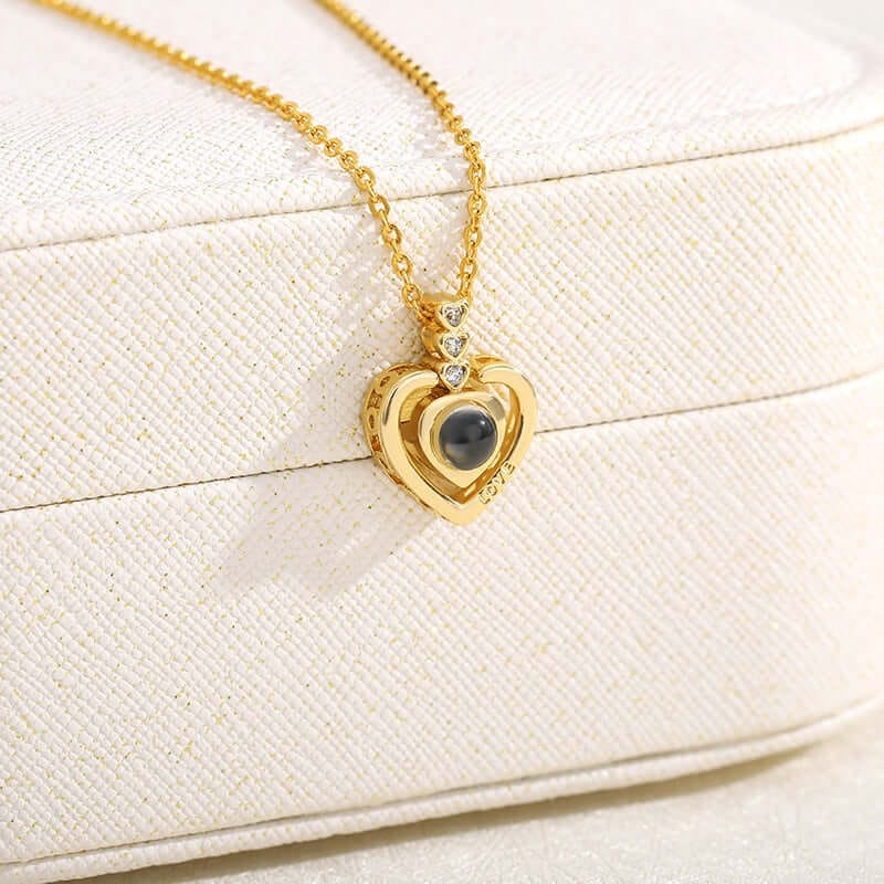 A close up photo of gold color I love you necklace focusing purely on the pendant of the necklace.  