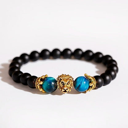 Lion head in gold color surrounded by two blue marble forming a bracelet with black beads